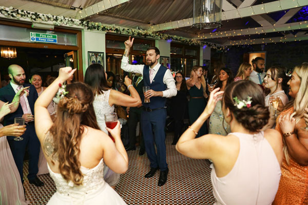 Groom dancing in the middle of the dance floor at the Knowle, Kent